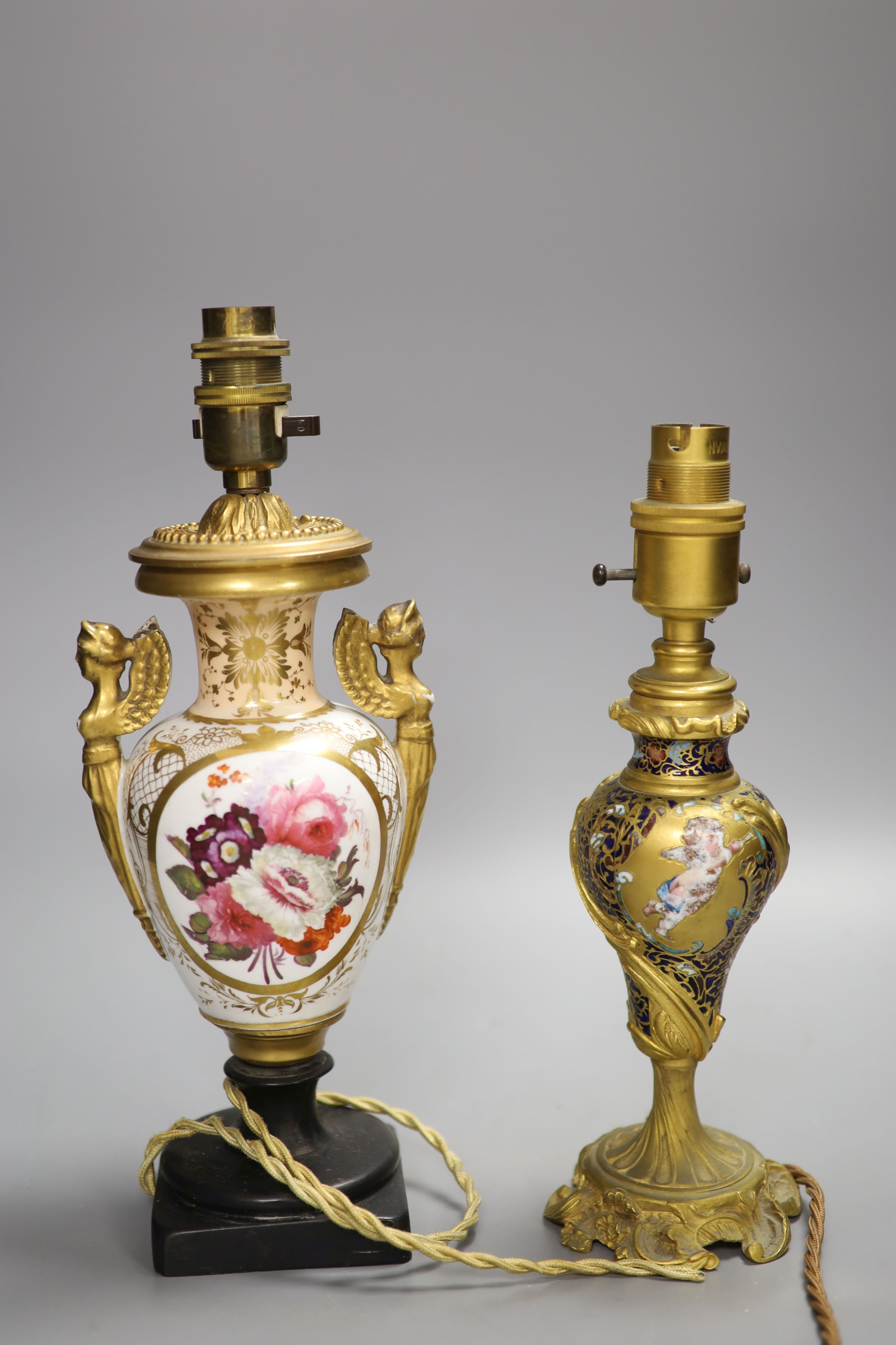 A Rococo revival champleve and ormolu converted table lamp, together with a floral painted porcelain table lamp, overall height 31cm